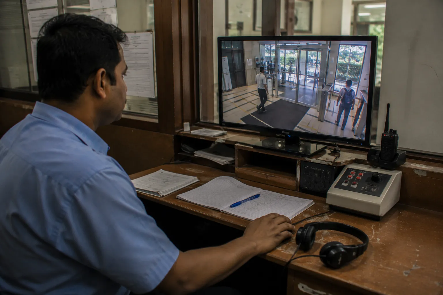 Staff member at a control desk monitoring a live occupancy readout