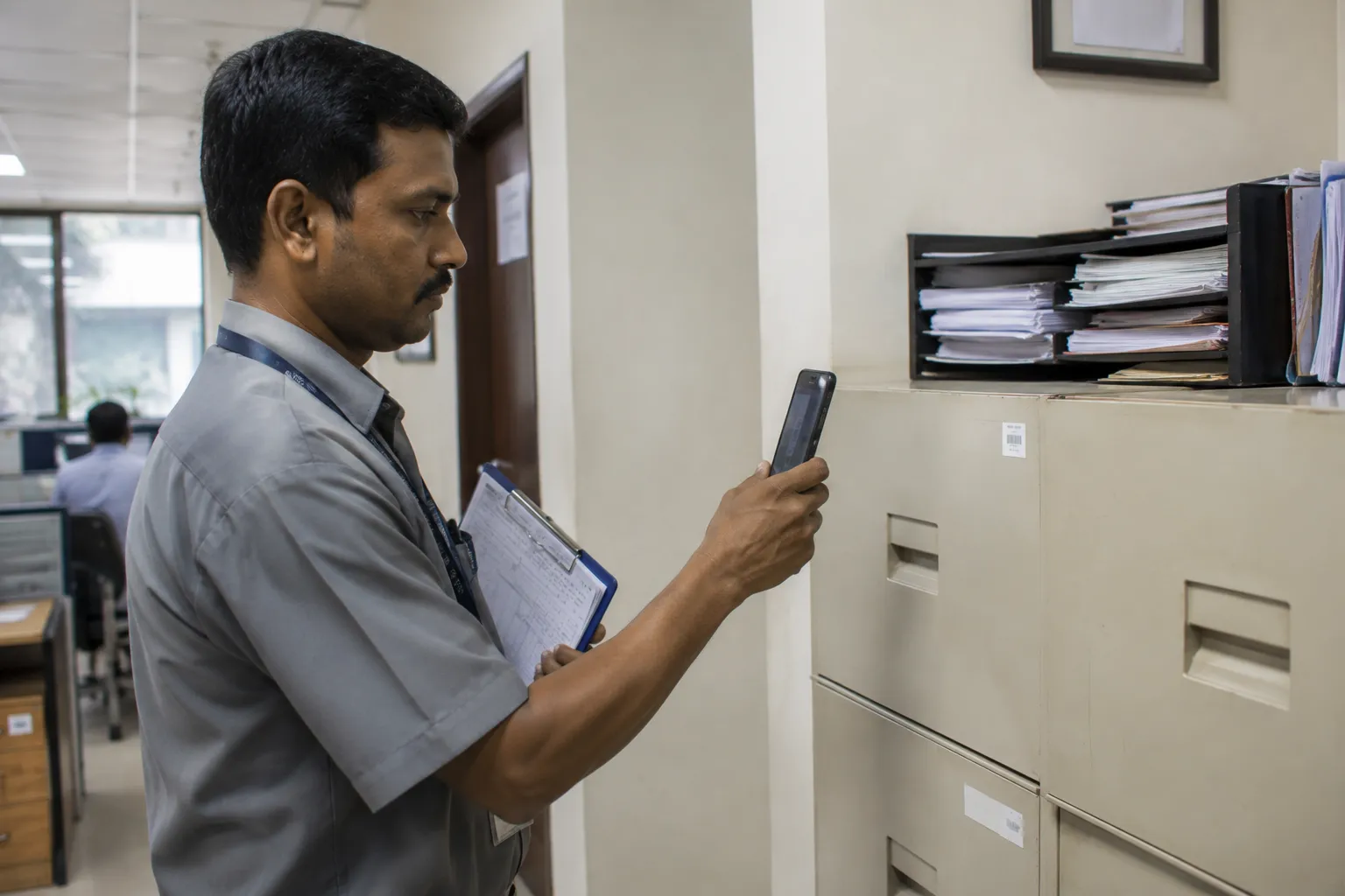 Facilities staff scanning an asset tag during a physical verification walk