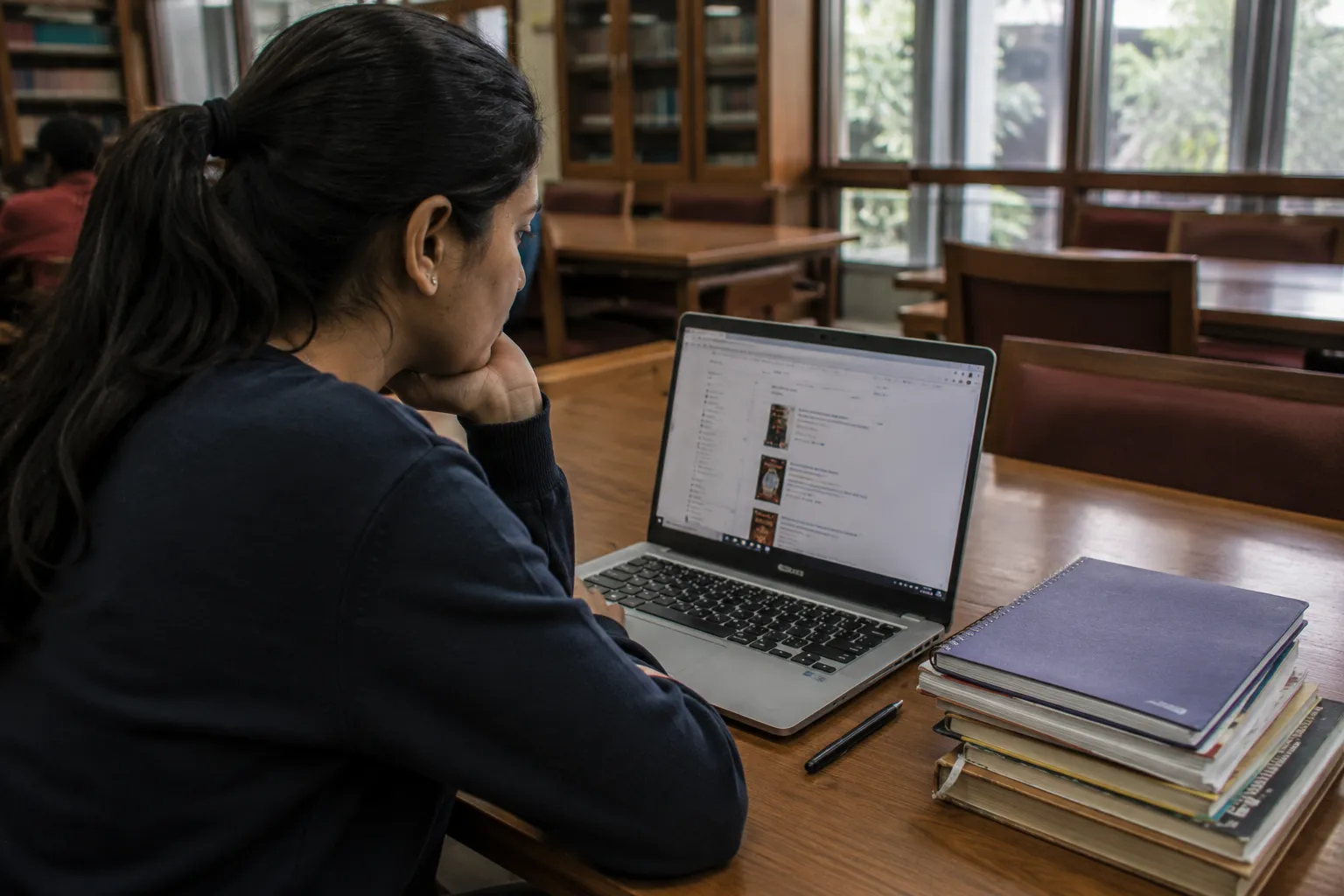 Student browsing the online library catalogue on a laptop